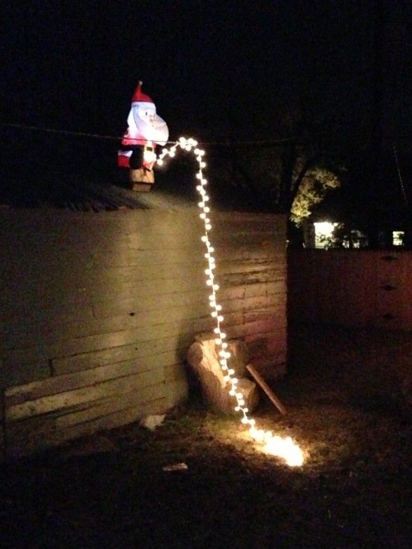 Santa peeing off roof